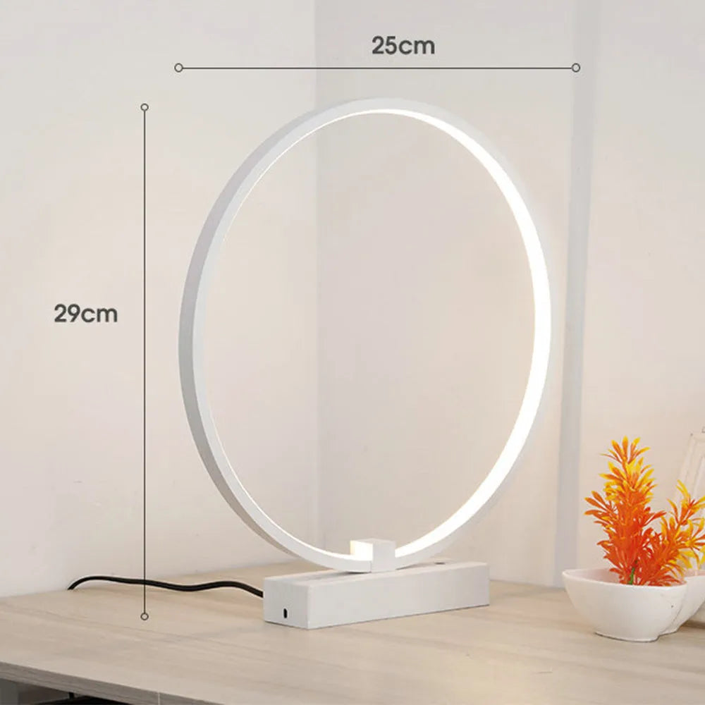 25cm round white LED bedside lamp with acrylic frame and iron base, shown in warm white or cool white
