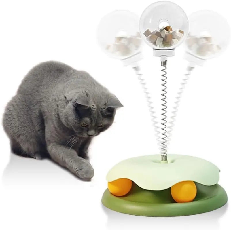 Blue and green PP plastic cat treat dispenser toy with a track ball on a textured base