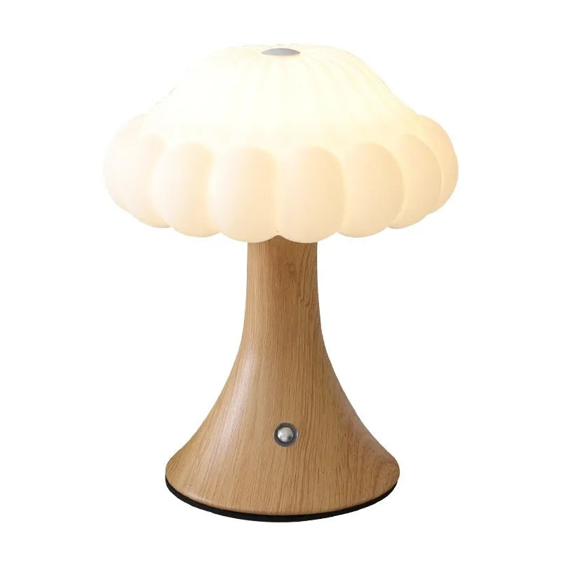 Mushroom-shaped charging touch night light in five colour options on wooden table