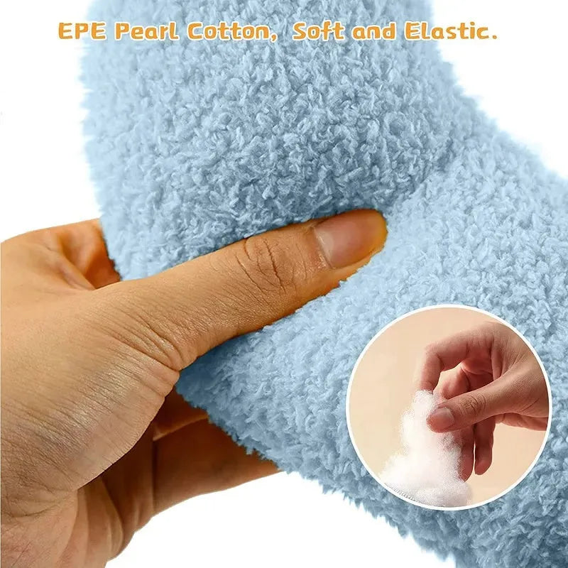 Small blue half-donut shaped pet pillow bed for cats or small dogs on a carpet.