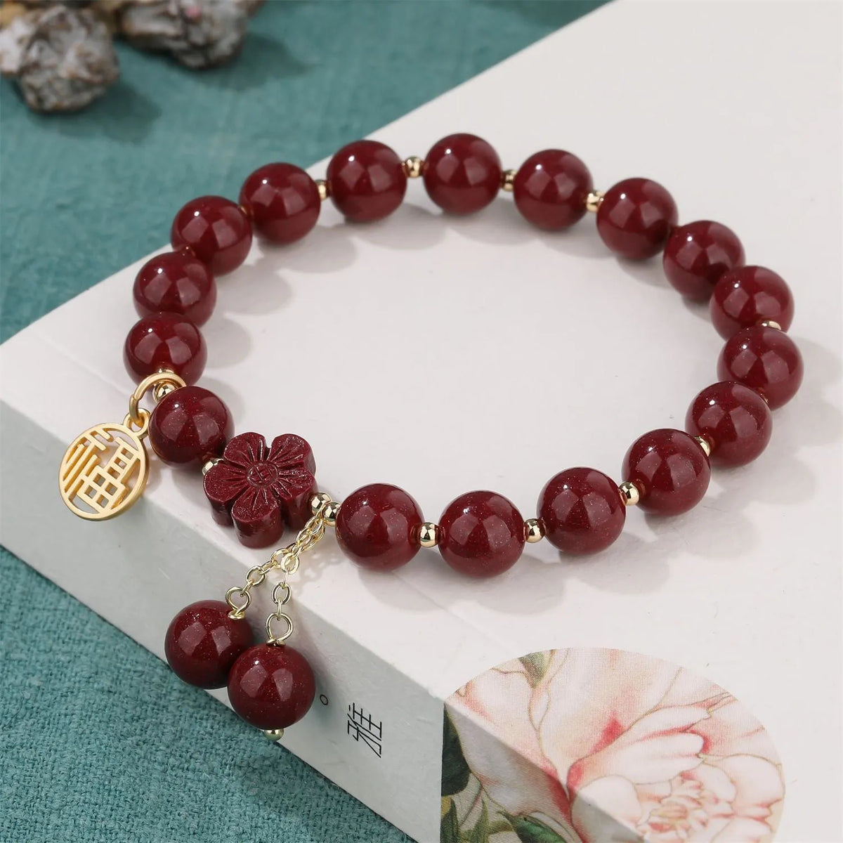 Women's cinnabar and purple gold sand bracelet with Fu character peach blossom or Hetian jade flower national style design and tassel detailing