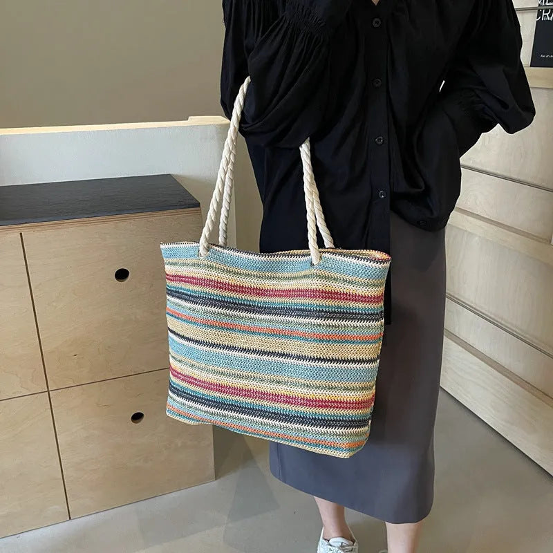 Blue woven shoulder bag with straw-effect pattern, large capacity design with single shoulder strap