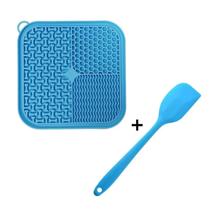 Blue silicone dog lick mat with textured pattern and suction cups on a table.