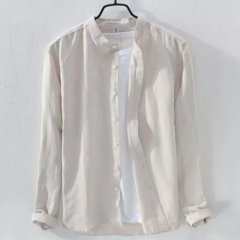 Man wearing a loose-fitting light blue long sleeve casual shirt made from cotton linen blend.