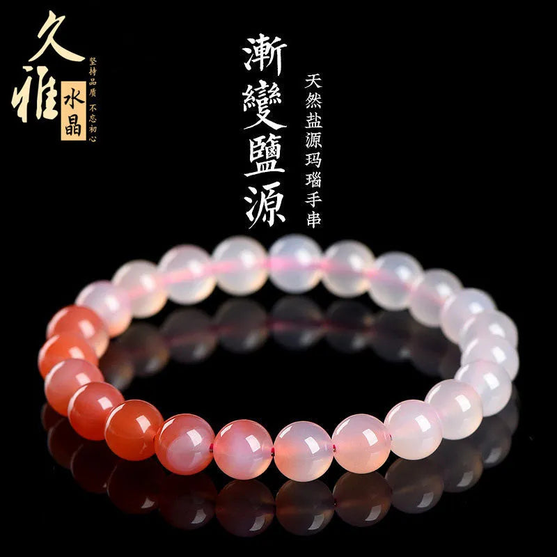 Natural gradient Yanyuan agate bracelet with geometric beads on a wrist, showing colour variation.