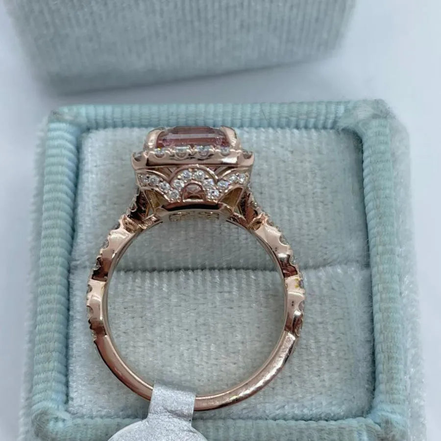 Geometric design rose gold alloy ring on a grey background, showing its clean lines and metallic finish.