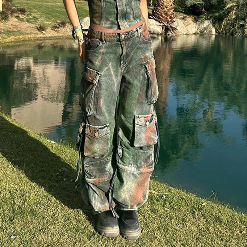 Loose blue denim cargo trousers with multiple gradient colour pockets and decorative stitching.