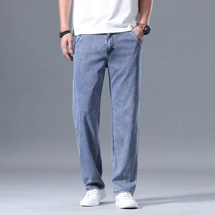 Men's loose straight-leg lyocell jeans shown in light blue colour with a zipper fly.