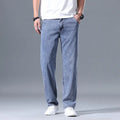 Men's loose straight-leg lyocell jeans shown in light blue colour with a zipper fly.