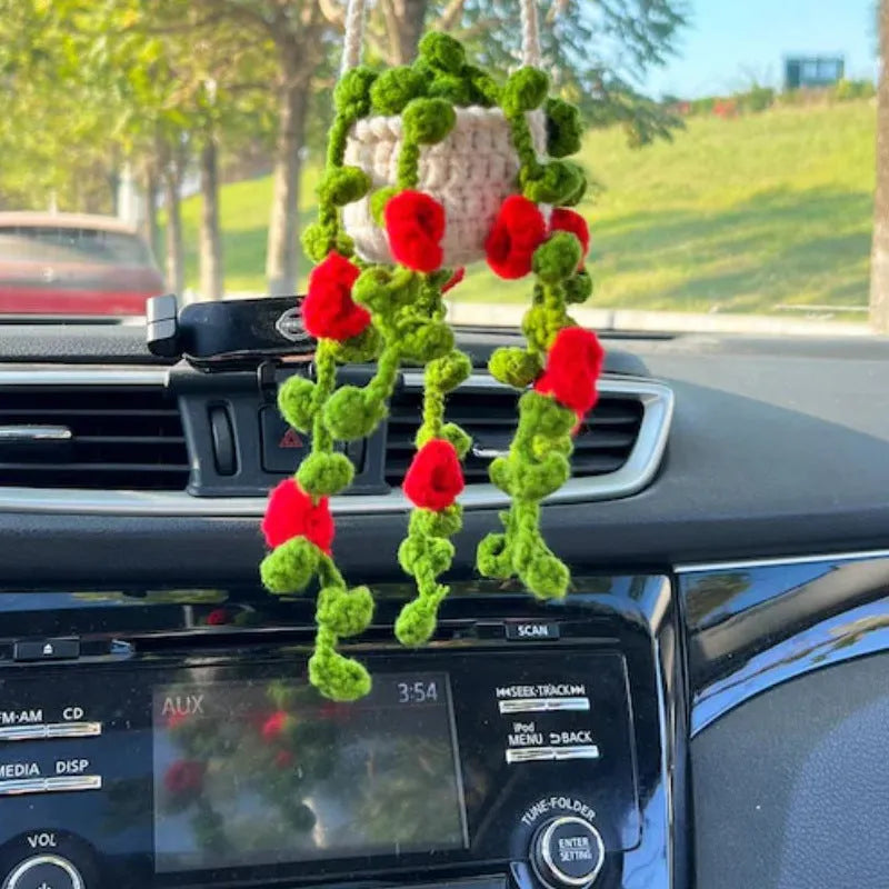 Green and white knitted wool car plant decoration with plastic base and hanging rope
