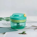 Green manual kitchen food grinder with 300ml capacity container and stainless steel cutting blades
