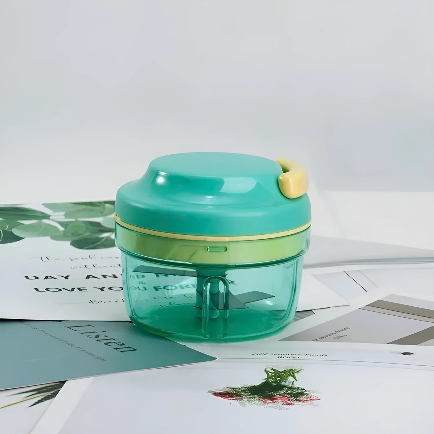 Green manual kitchen food grinder with 300ml capacity container and stainless steel cutting blades