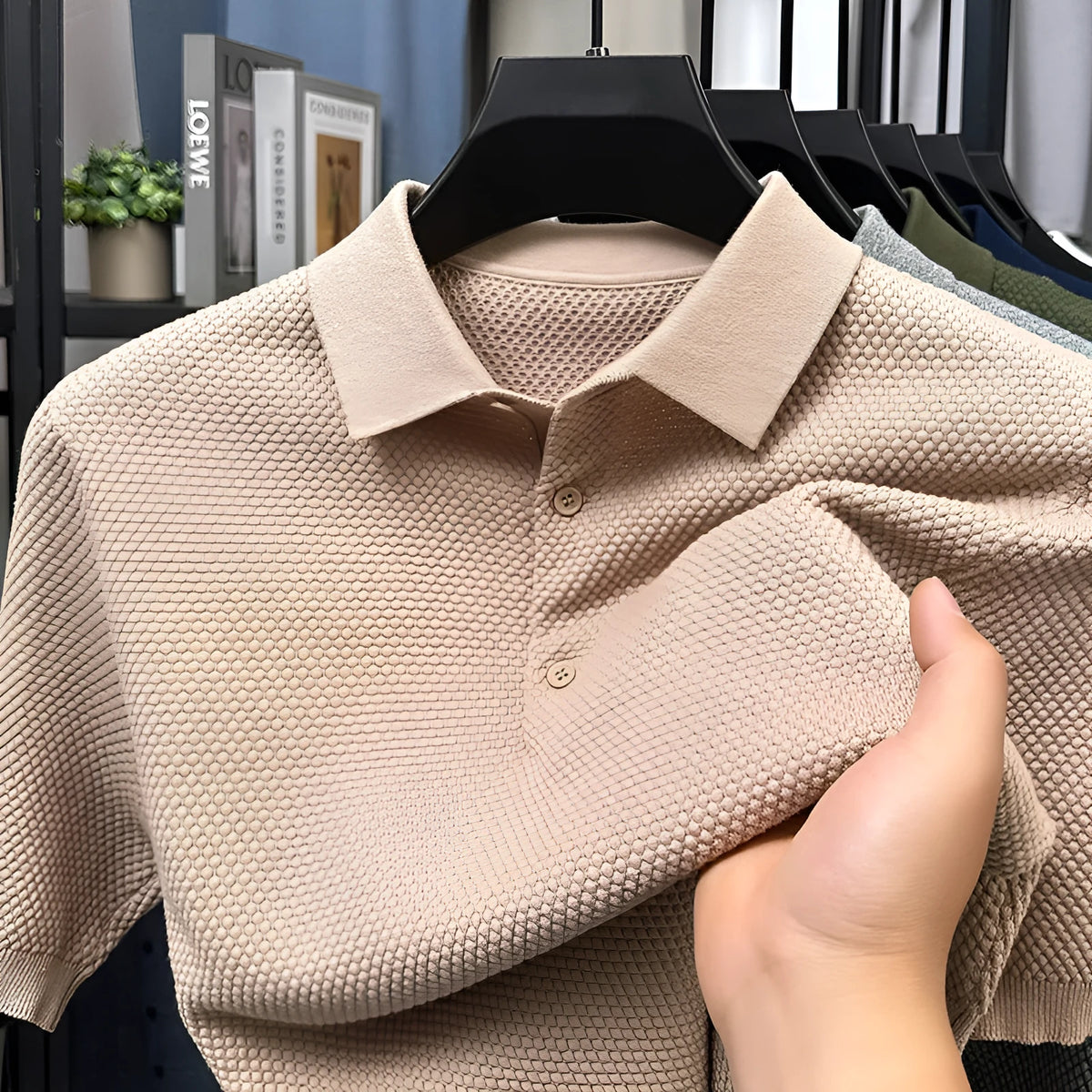 A loose-fitting short sleeve cotton pullover sweater on a hanger, shown in one of the six available colours.