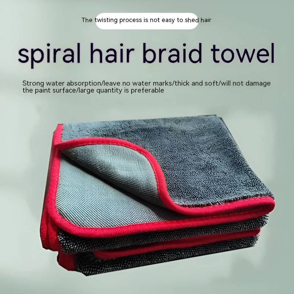 Grey car wash towel with black trim edge, showing hemmed border and spiral hair texture.