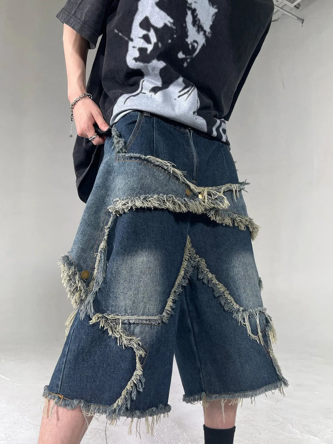 Blue denim shorts with frayed details and five-pointed star design, loose fit summer shorts