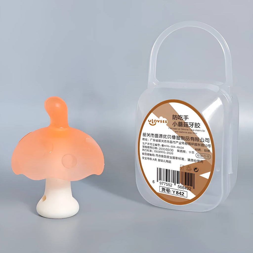 Small mushroom-shaped latex chewable gum on a transparent chain next to a clear storage box.