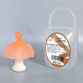 Small mushroom-shaped latex chewable gum on a transparent chain next to a clear storage box.