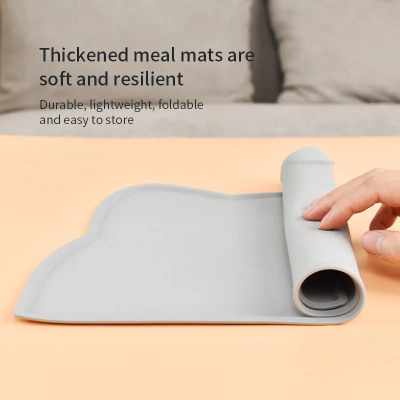 Blue silicone pet feeding mat with cat head shape under dog bowl