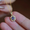 Yellow gold mixed gem pendant necklace with inlaid zircon stones on a box chain.
