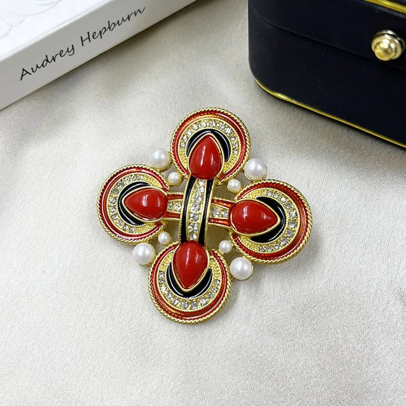 Classic vintage zinc alloy brooch with baroque-style cross design and crystal details on a dark background.