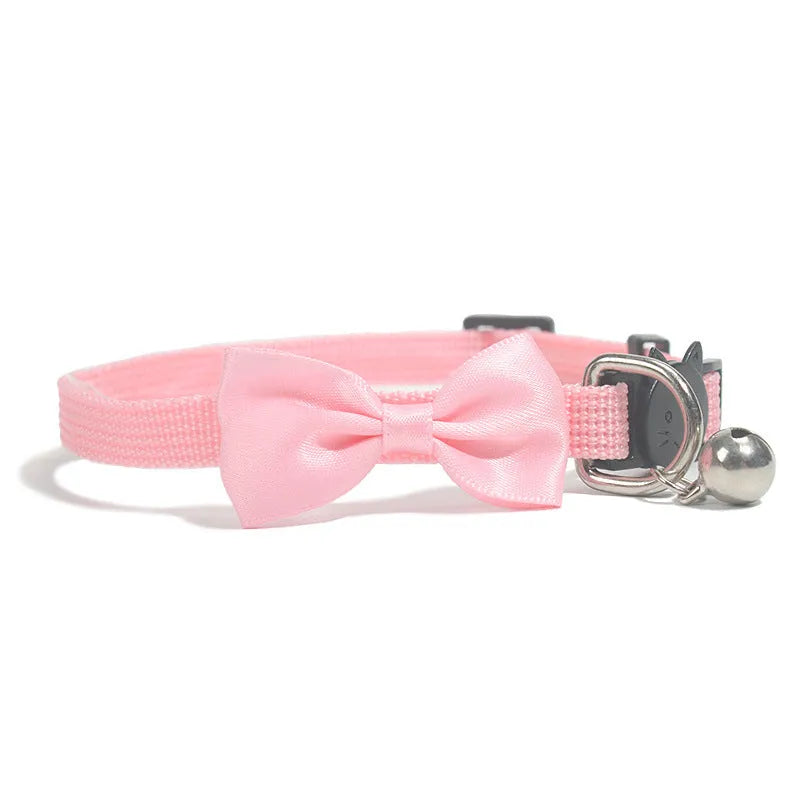 Adjustable striped nylon cat collar with bell in various colors including red, green, and blue