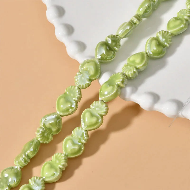 Love heart shaped torch ceramic beads in various colours including cream white, pinks, blues and greens for jewellery making