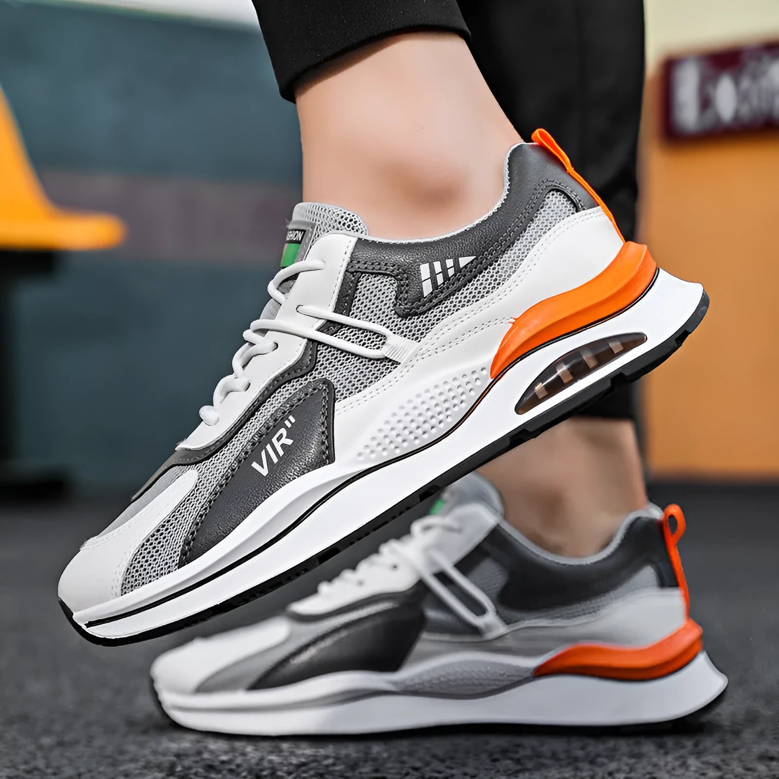 Men's grey mesh running shoes with mid-top height and rounded toe design on white background