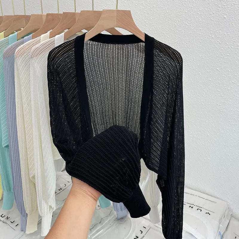 Women's lantern sleeve blouse in apricot colour with hollow thin fabric and long sleeves.