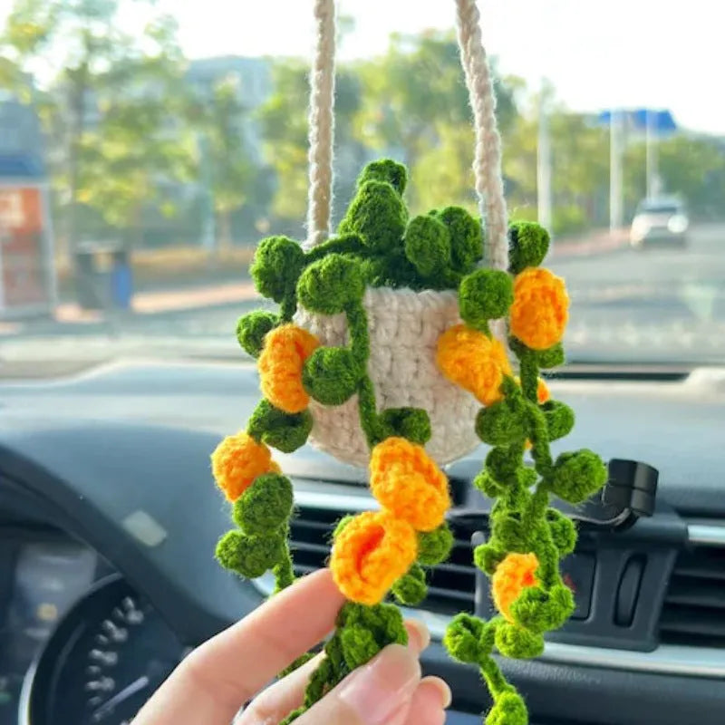 Green and white knitted wool car plant decoration with plastic base and hanging rope