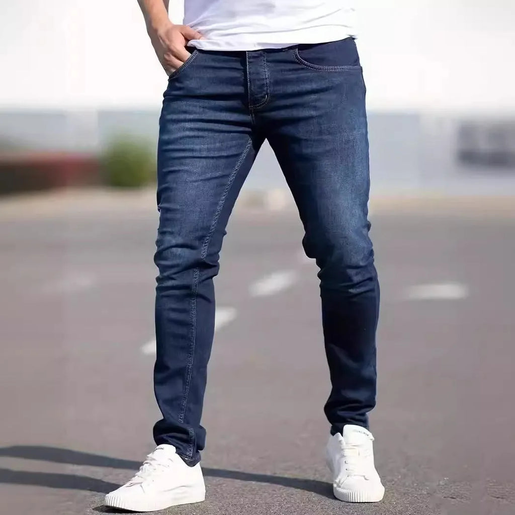 Men's dark blue cotton skinny jeans with elastic waistband shown on model