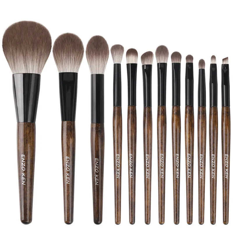 A 12-piece makeup brush set with soft bristles and wooden handles in a PU brush bag