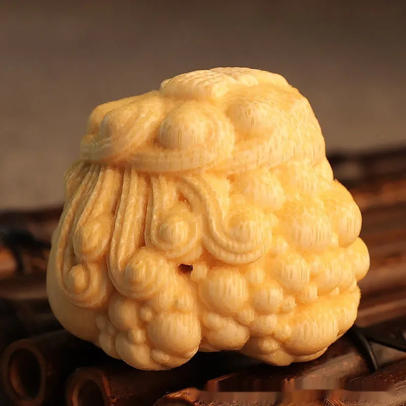 Golden Toad Princess ornament carved from solid bamboo on a wooden surface.