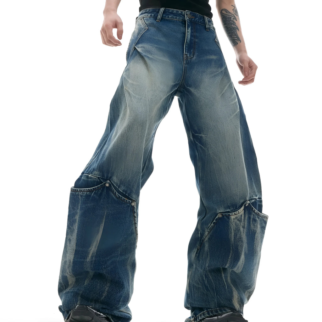 Men's verdant blue jeans with retro washed burst pattern showing curved knife fit and loose styling