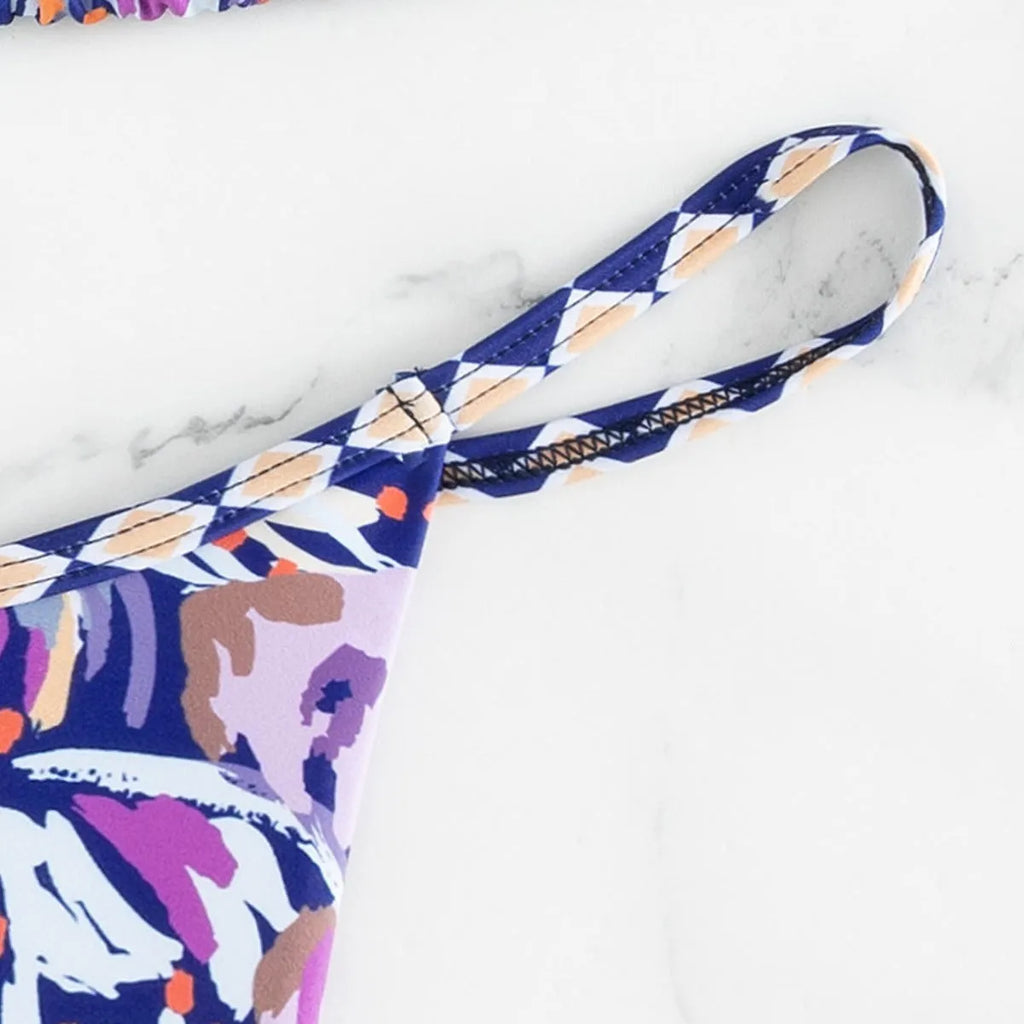 Women's floral print triangle swimsuit with briefs bottom and integrated bag.