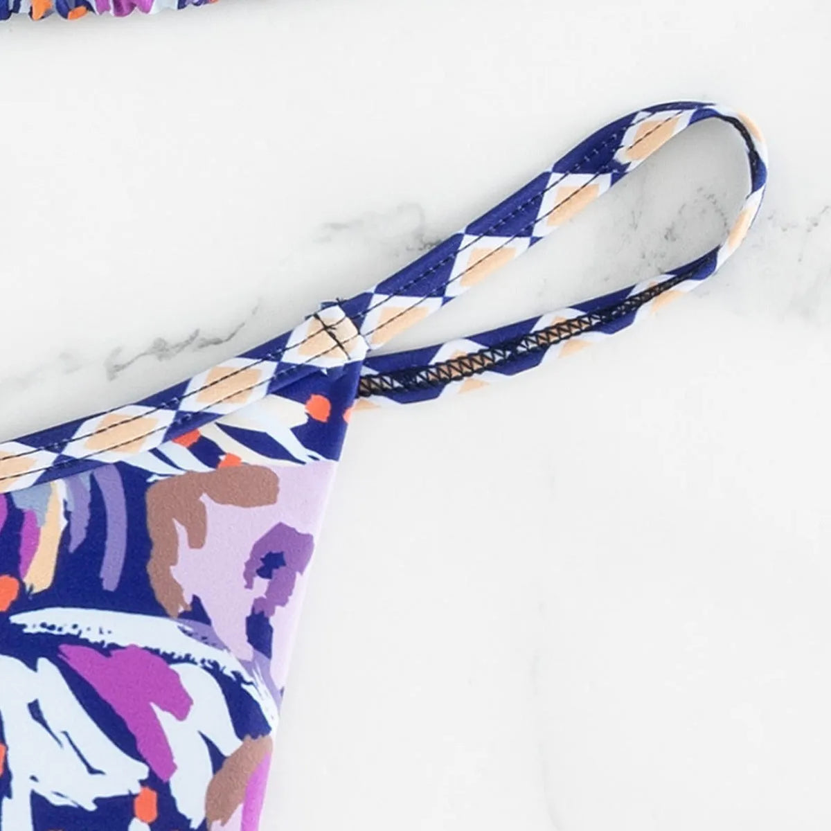 Women's floral print triangle swimsuit with briefs bottom and integrated bag.