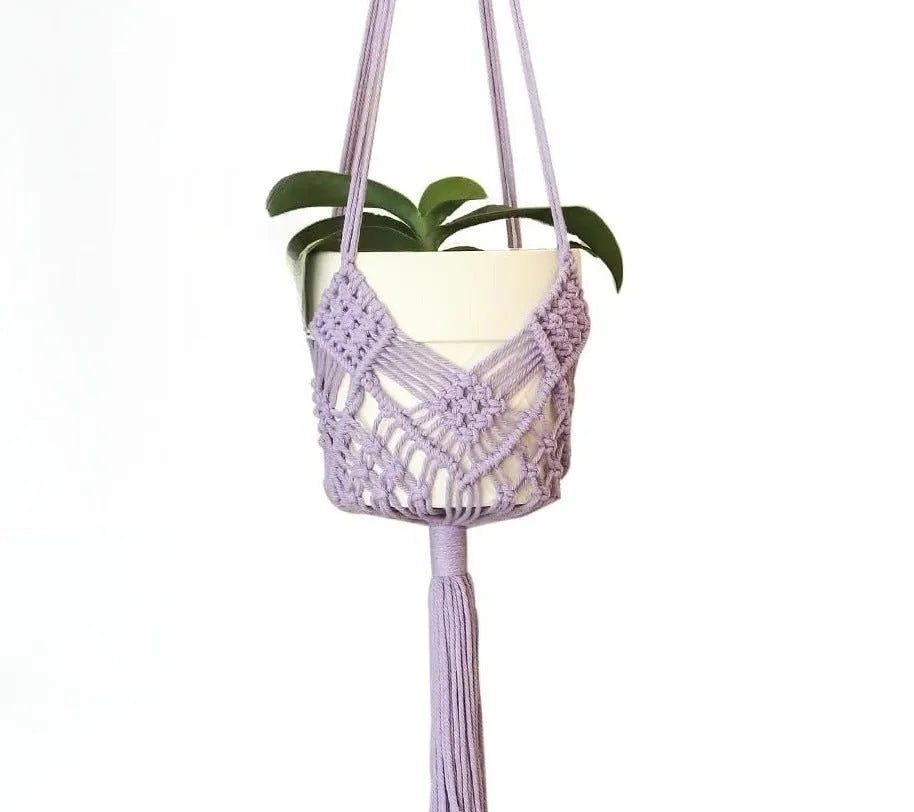 Hand-woven brown polyester cotton net pocket extension cord on a grey flower pot.