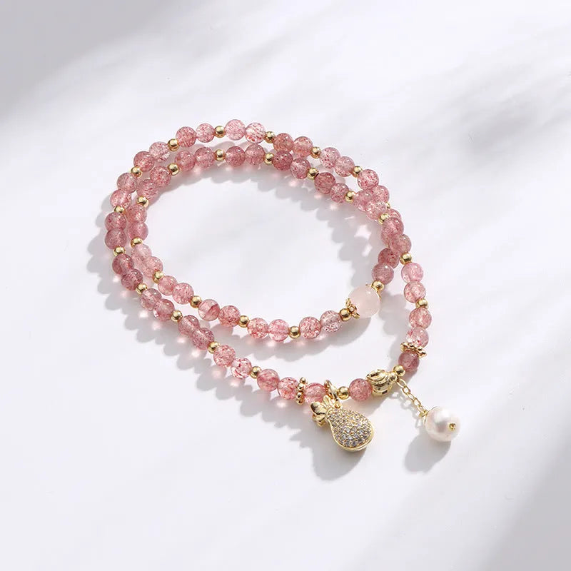 Women's strawberry quartz crystal bracelet with a geometry shape design.