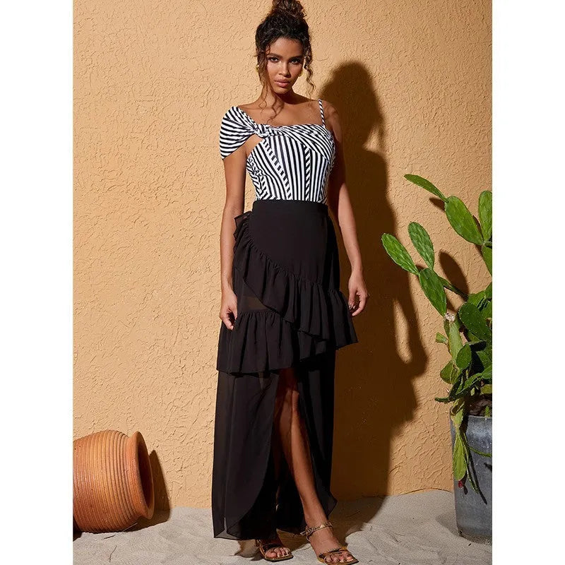 Women's striped one-piece swimsuit with ruffled detailing and black skirt attachment