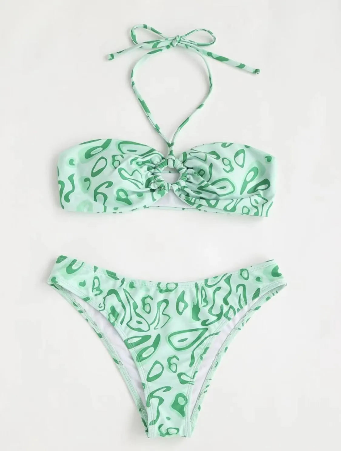 Green floral bandeau bikini swimsuit set with briefs on a neutral background.