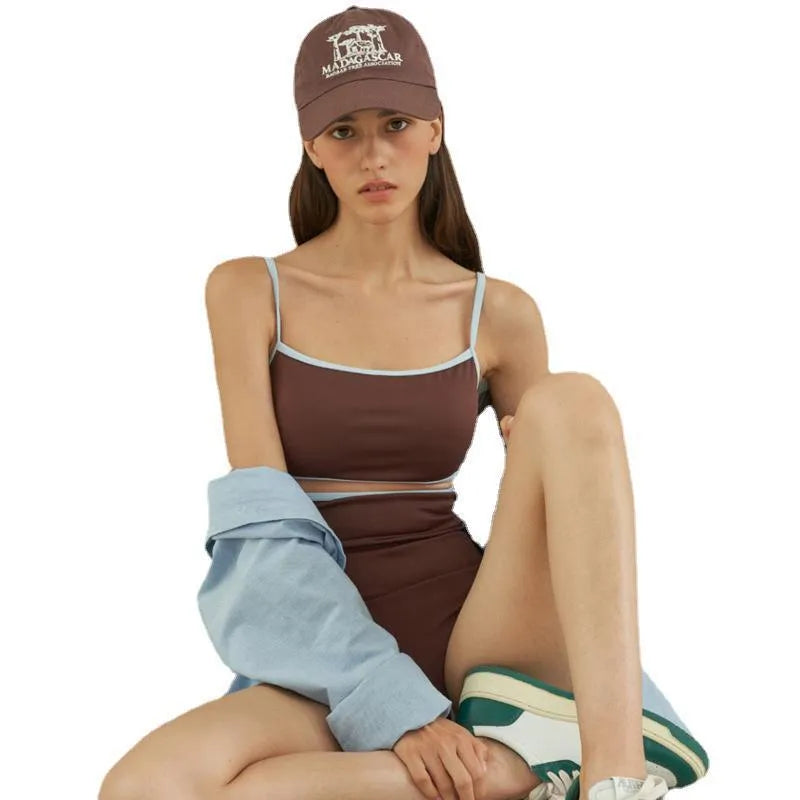 Brown women's one-piece swimsuit with triangle style on a hanger.