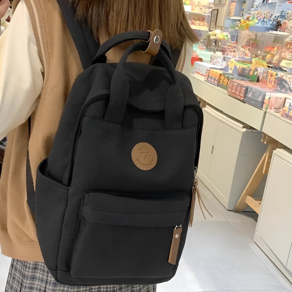 Black Oxford cloth backpack with curved shoulder straps and urban simplicity design