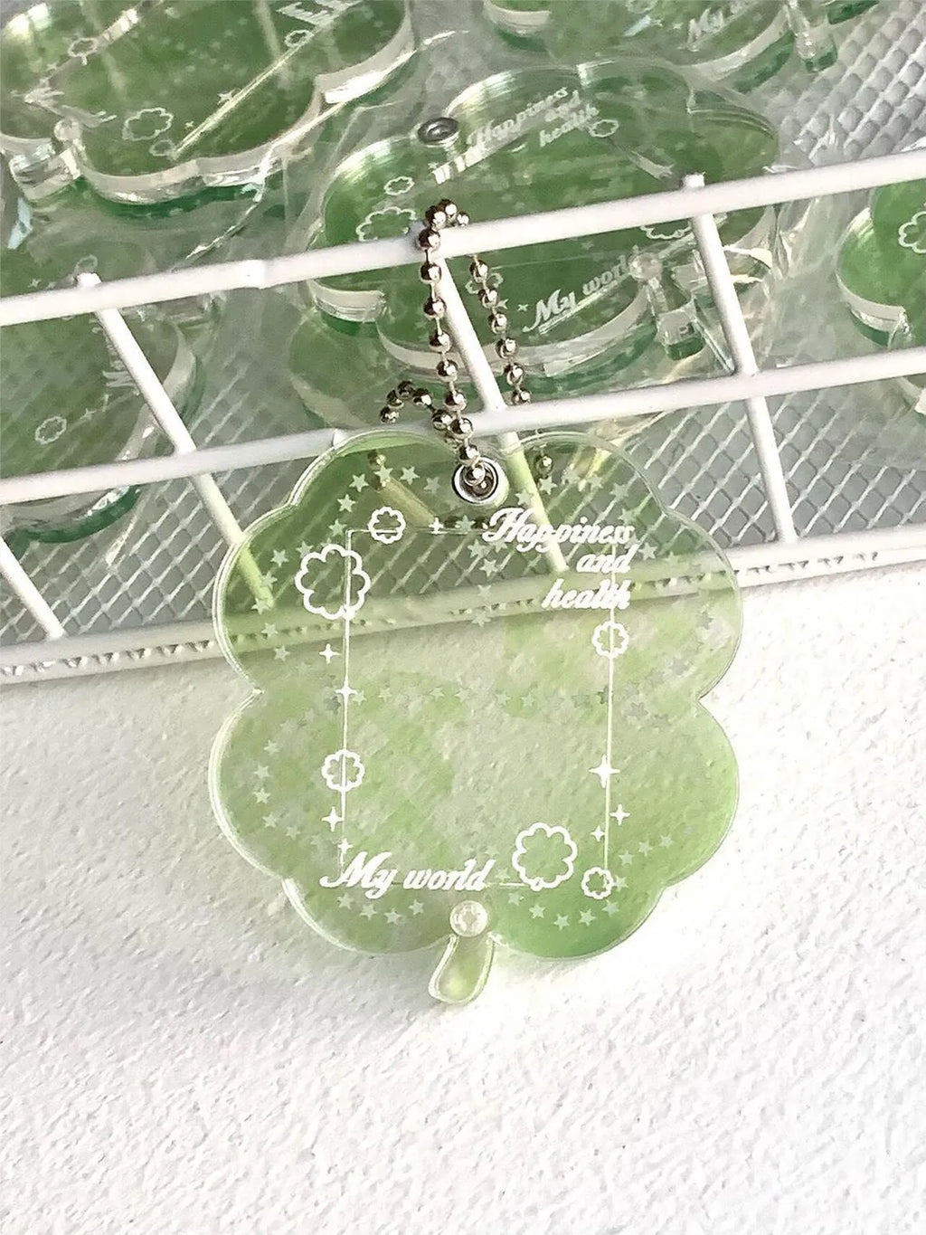 Acrylic four-leaf clover pendant keychain in elegant blue, grass green, and mint green colours.