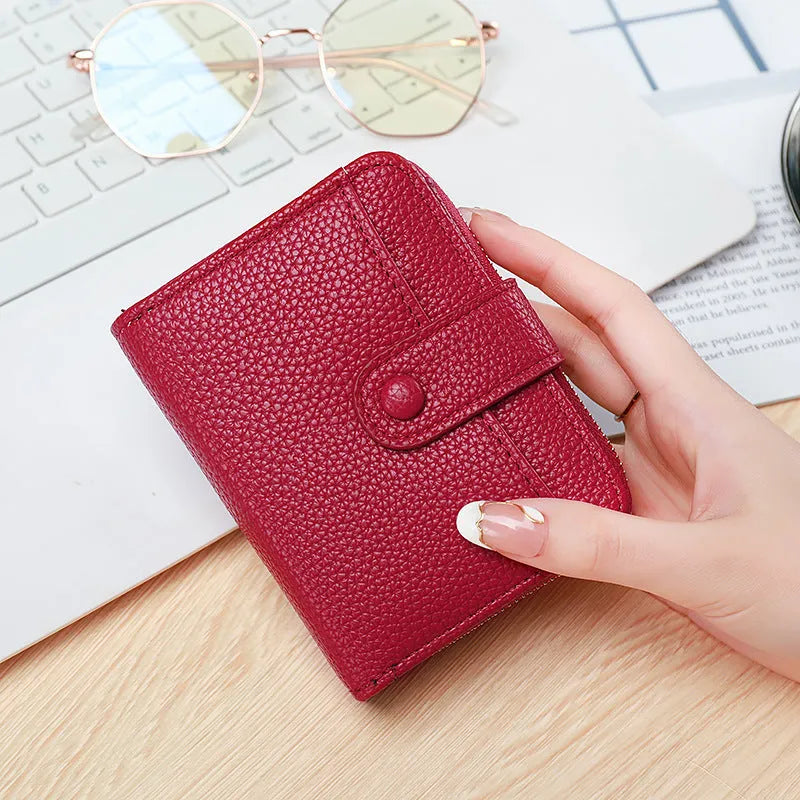 Ladies' short PU leather wallet with a lychee pattern, shown folded, in beige, pink, black, and red colour options.