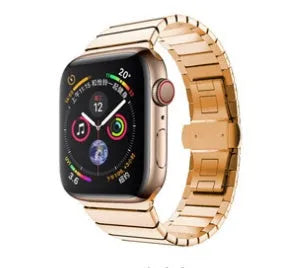 Silver stainless steel Apple Watch strap with butterfly buckle on a wrist.