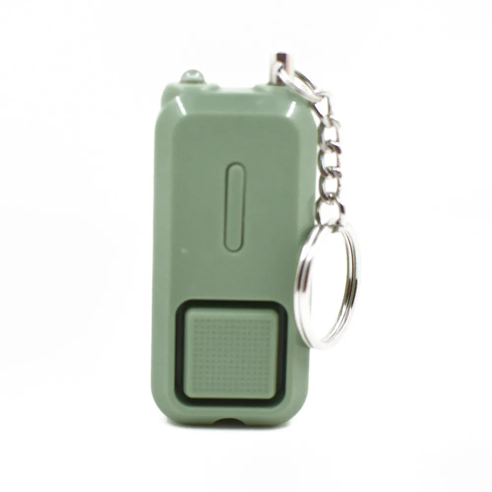 Compact pink personal safety alarm for women with keychain, shown next to its white box.
