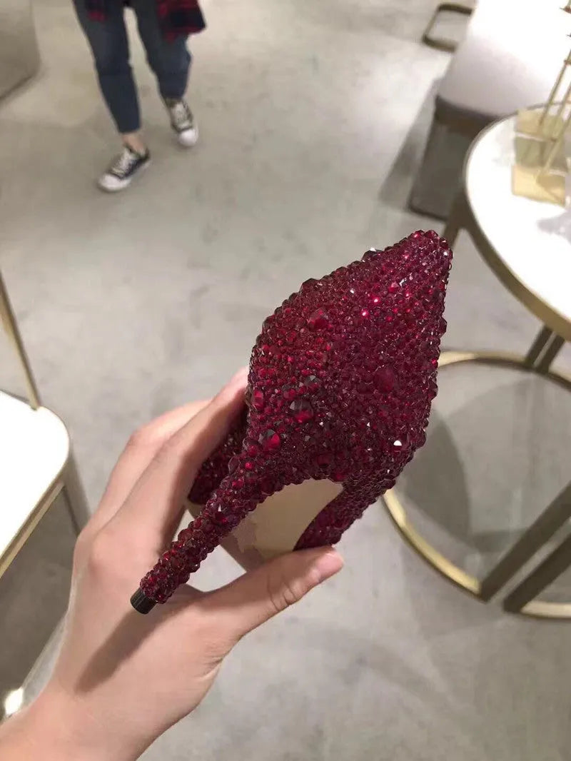 Women's gold high heel shoes with rhinestone detailing and pointed toe design
