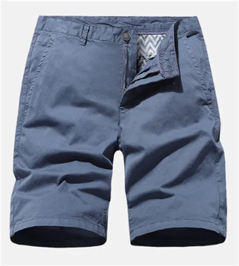 Men's loose-fit printed denim shorts in blue, shown in a casual setting.