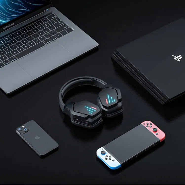 Luminous black wireless over-ear gaming headphones shown with a 3.5mm audio cable and dust bag.