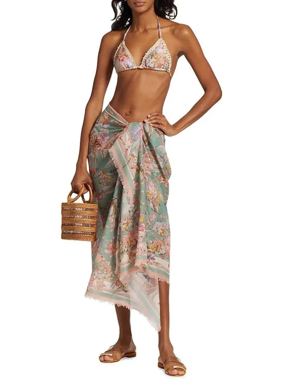 Creamy white women's floral bikini set with top, briefs, and matching skirt on a mannequin.