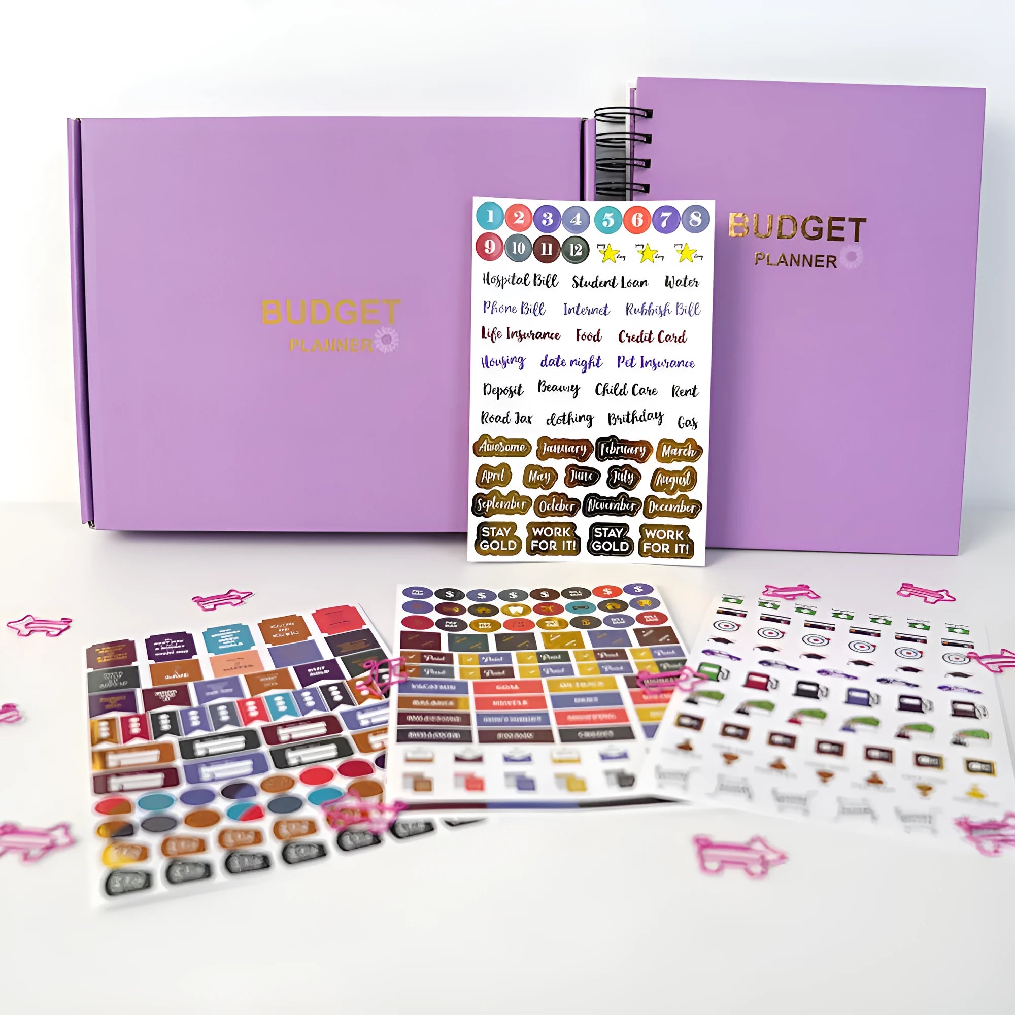 Purple coil-bound budget notebook with stickers for monthly financial planning showing Daolin paper pages